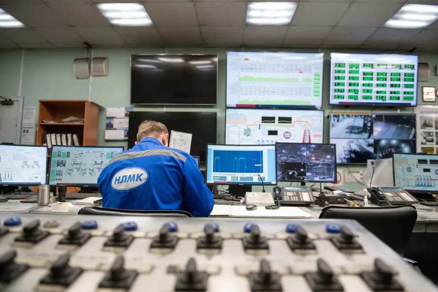 Safety operator supervising a multi-screen control room