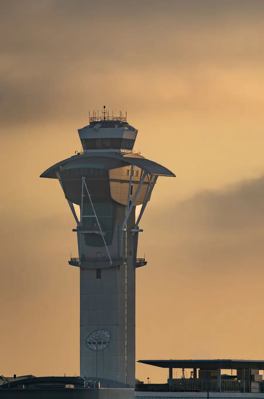 Conventional staffed airport control tower at sunset